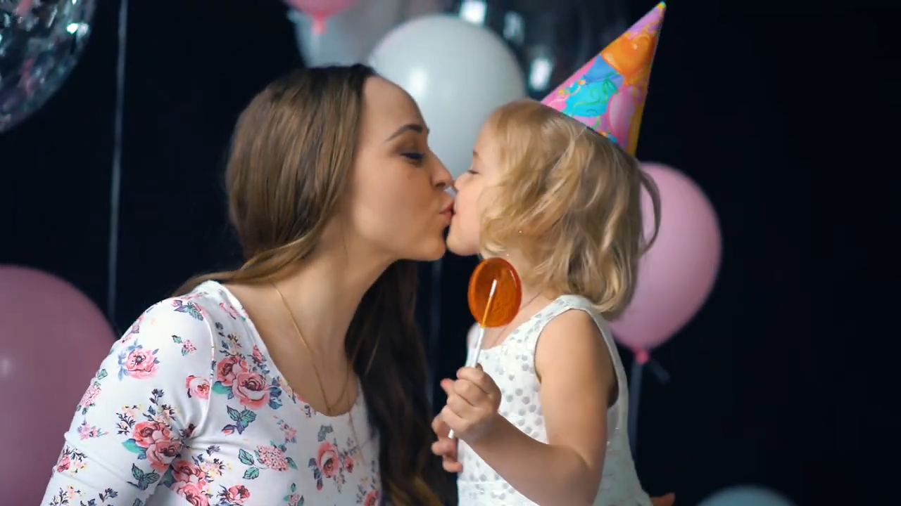 Mom and daughter kissing